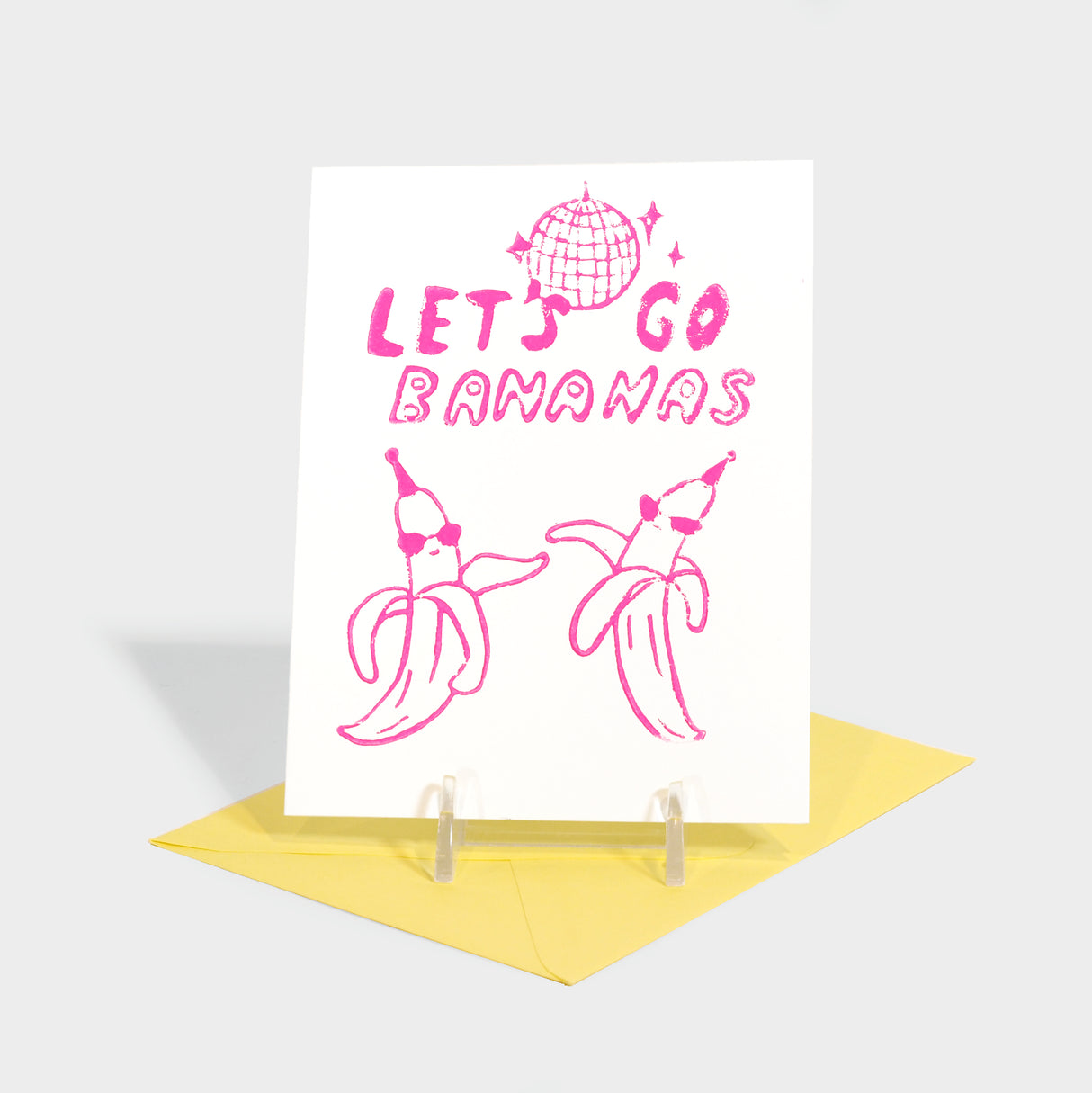 Greeting card with bananas partying under a disco ball illustration