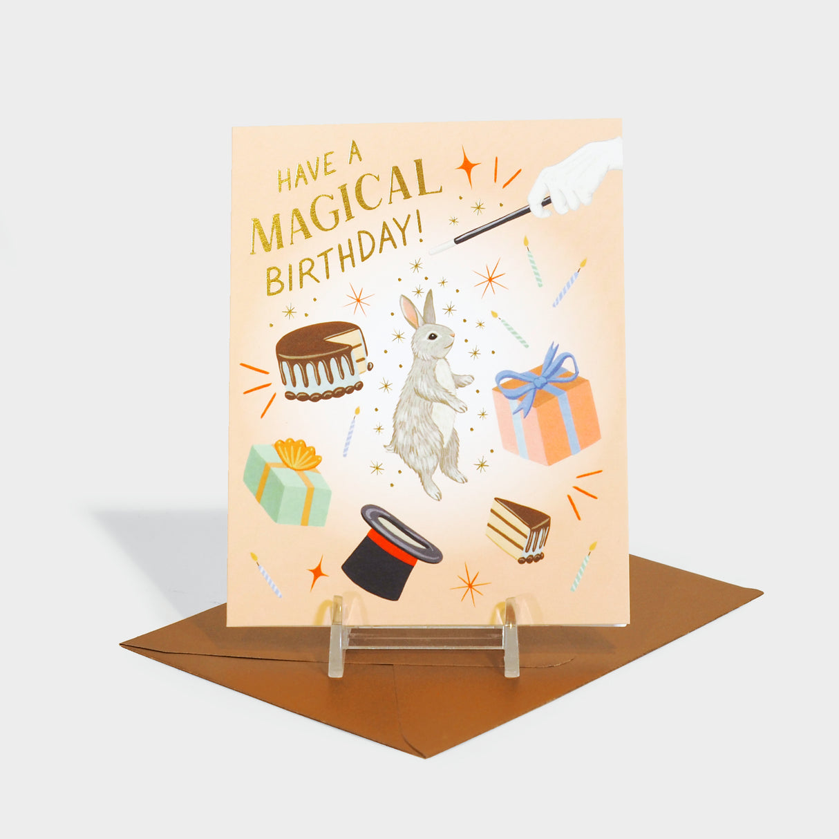 Greeting card featuring birthday cake, presents, and classic magician motifs: a top hat, a rabbit, and hand with a wand.