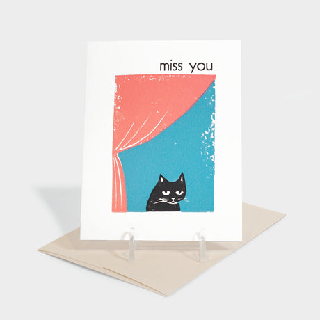 Greeting card with illustration of a cat looking out a window.
