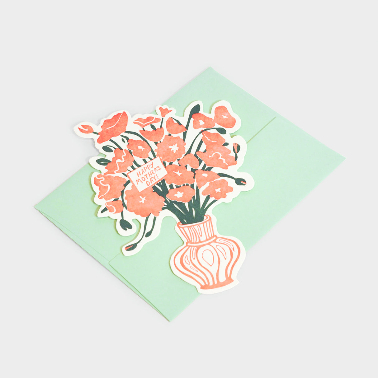 Letterpress, die-cut greeting card of a floral bouquet in a vase.