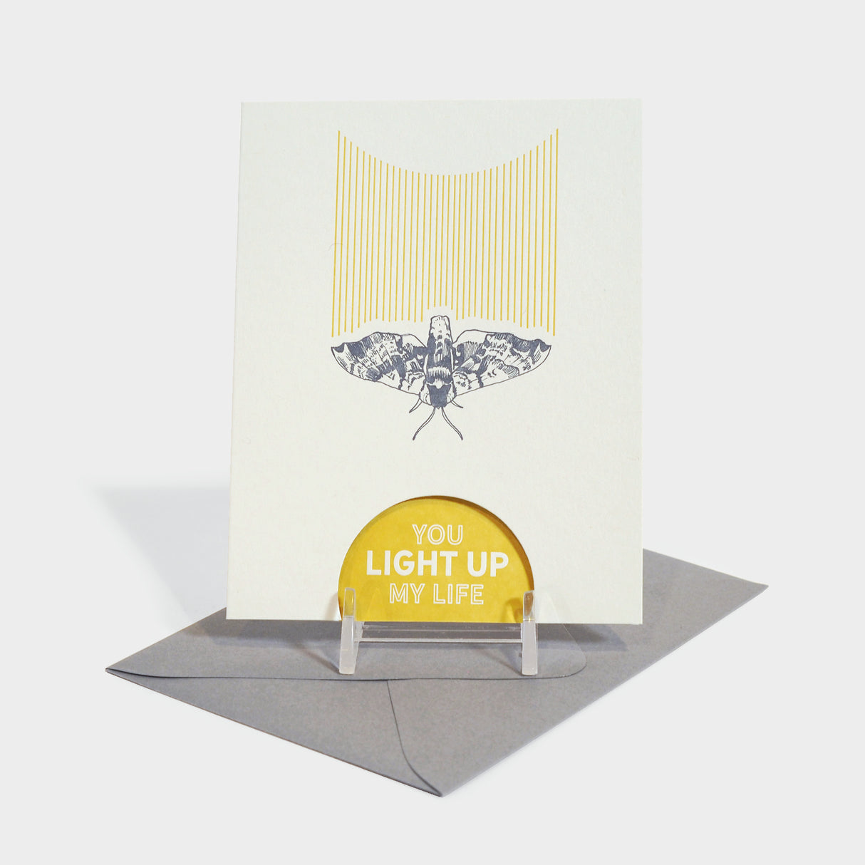 Greeting card with letterpressed moth motif. Card has a die-cut semi-circle where the text is printed on the inside, visible from the outside.