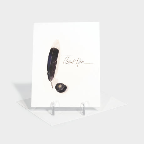 Greeting card with illustration of a feather quill and ink well.