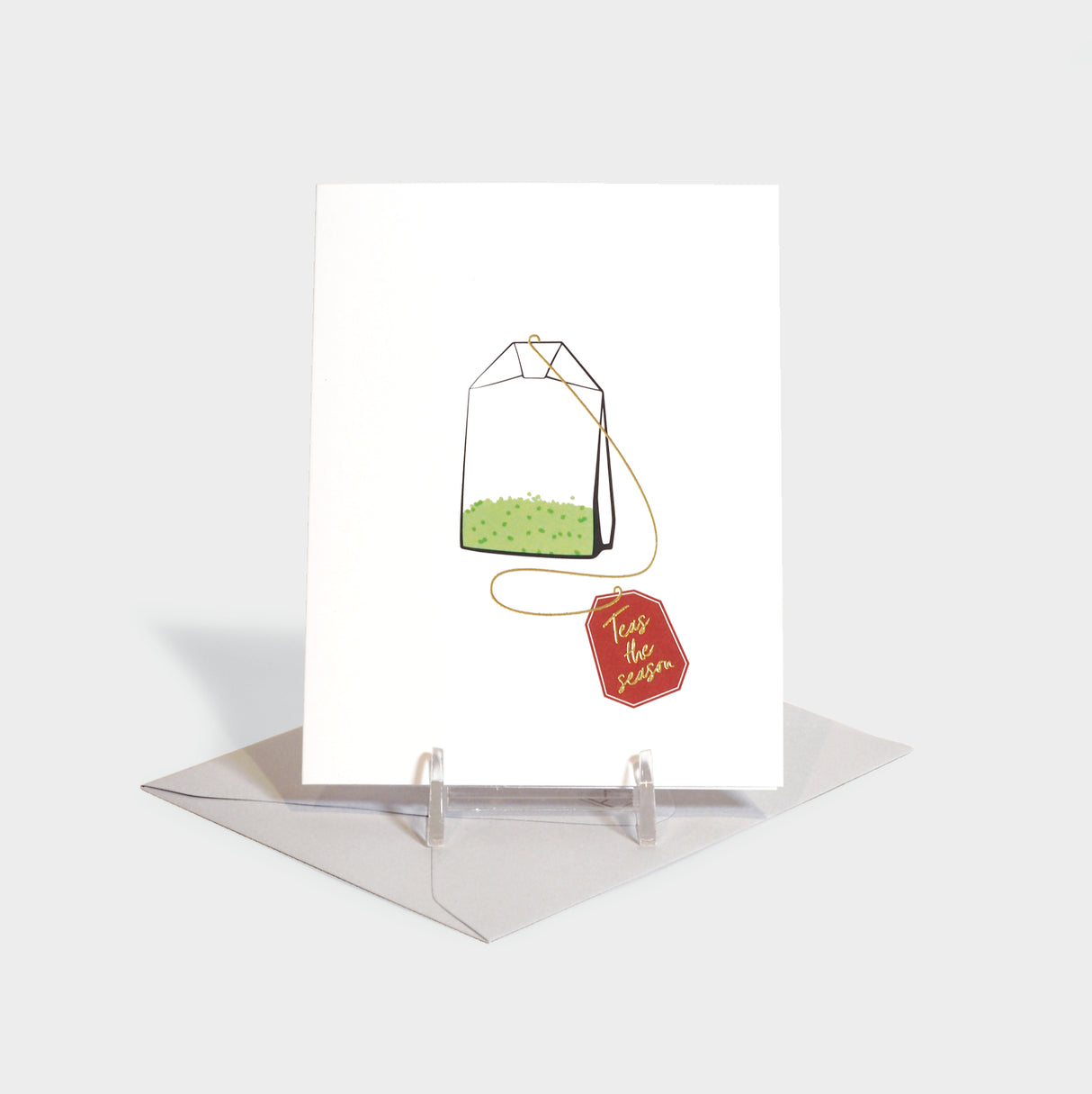 Greeting card featuring an illustration of a tea bag with a tag that reads, "teas the season."