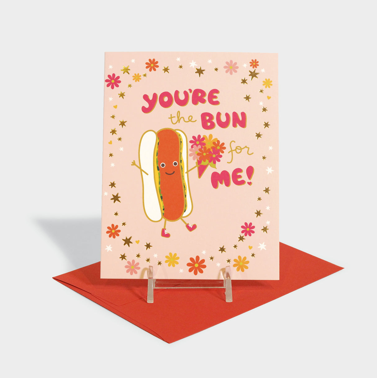 Greeting card with hot dog holding a bouquet.