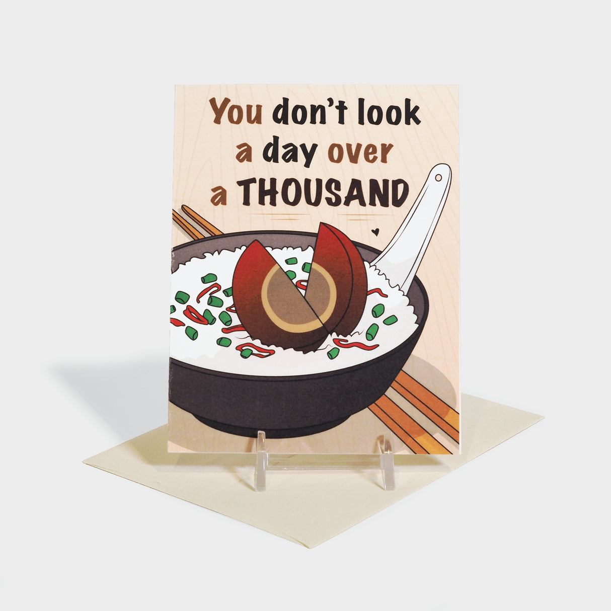 Greeting card with illustration of a rice bowl with a century egg in the center.