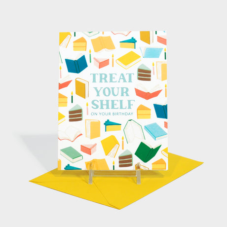 Greeting card with illustrated book and cake motifs.